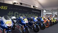 VALENCIA, SPAIN - NOVEMBER 11: Carmelo Ezpeleta (R) of Spain and Dorna CEO and Valentino Rossi of Italy and Petronas Yamaha SRT pose near the 9 bikes with which he won the World Championships in paddock during the MotoGP of Comunitat Valenciana: Previews at Ricardo Tormo Circuit on November 11, 2021 in Valencia, Spain. (Photo by Mirco Lazzari gp/Getty Images)